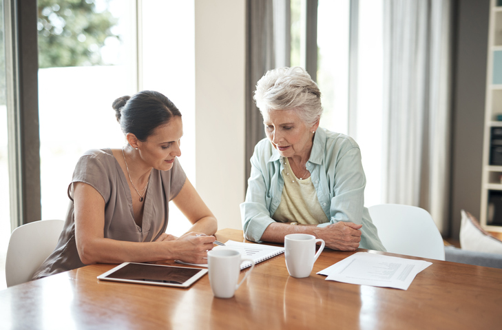Older woman working on estate plan with her daughter
