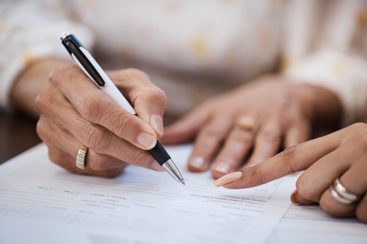 Woman signing estate planning document