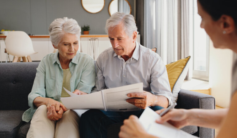 Senior couple reviewing estate plan with attorney